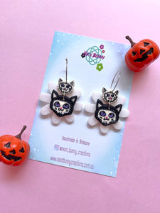 Skeleton kitty daisy earrings